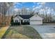 Charming single-story home with well-manicured lawn, mature trees, and attached two-car garage at 781 Woodlawn Ave, Mount Holly, NC 28120