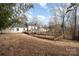 Large backyard with a spacious wooden deck, perfect for outdoor activities and enjoying the view at 8025 Cliffside Dr, Charlotte, NC 28270