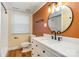 Updated bathroom features modern vanity with elegant fixtures and a stylish round mirror at 8025 Cliffside Dr, Charlotte, NC 28270