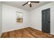 Bright bedroom features hardwood floors, a ceiling fan, and a window to let in natural light at 8025 Cliffside Dr, Charlotte, NC 28270