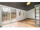 Bedroom featuring sliding glass door access to a back deck and a large window at 8025 Cliffside Dr, Charlotte, NC 28270