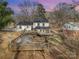 Charming white home featuring a spacious wooden deck and a fenced yard, perfect for outdoor entertaining at 8025 Cliffside Dr, Charlotte, NC 28270