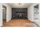 Living room showcasing a painted brick fireplace and neutral walls at 8025 Cliffside Dr, Charlotte, NC 28270