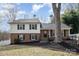 Classic two-story home with brick facade, vinyl siding, and green shutters at 8025 Cliffside Dr, Charlotte, NC 28270