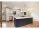 Kitchen with dark island, white cabinets, stainless steel appliances and hardwood floors at 8025 Cliffside Dr, Charlotte, NC 28270