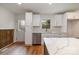 Modern kitchen with stainless steel appliances, white cabinets, and a large island at 8025 Cliffside Dr, Charlotte, NC 28270