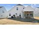 Backyard view with a small outdoor patio area, covered patio, and newly planted grass at 8348 Acadia Pkwy, Sherrills Ford, NC 28673