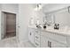 Bathroom with a double sink vanity, white cabinets, modern fixtures, and access to walk-in closet at 8348 Acadia Pkwy, Sherrills Ford, NC 28673