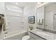 Clean bathroom with granite countertop, white bathtub, and gray tile at 8348 Acadia Pkwy, Sherrills Ford, NC 28673