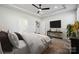 Bedroom featuring a ceiling fan, mounted TV, ensuite bathroom, and modern furnishings at 8348 Acadia Pkwy, Sherrills Ford, NC 28673