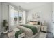 Sun-filled bedroom with neutral tones, large window, and a bench at the foot of the bed at 8348 Acadia Pkwy, Sherrills Ford, NC 28673