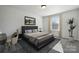 Bedroom featuring a large window, a desk, a dark blue bed frame, and grey carpet at 8348 Acadia Pkwy, Sherrills Ford, NC 28673