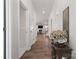 Hallway with a view into the living room, featuring hardwood floors and white trim at 8348 Acadia Pkwy, Sherrills Ford, NC 28673