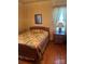 Traditional bedroom with a wooden bed frame, colorful quilt, and hardwood flooring at 897 Mocksville Hwy, Statesville, NC 28625