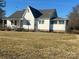 This is the exterior of a classic home with a sunroom and a neatly landscaped yard at 897 Mocksville Hwy, Statesville, NC 28625