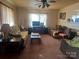 Vintage style living room with carpet, furniture, and a ceiling fan at 897 Mocksville Hwy, Statesville, NC 28625