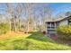 Landscaped backyard of home featuring green grass, mature trees and a deck at 10 Catawba Ridge Ct, Clover, SC 29710