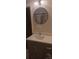 Bathroom vanity features gray cabinets and a round mirror at 105 N Inman Ave, Bessemer City, NC 28016