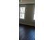 Bedroom with hardwood floors and two windows at 105 N Inman Ave, Bessemer City, NC 28016