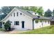 Angle view of white home with multiple windows and a gray roof, complemented by lush green grass at 105 N Inman Ave, Bessemer City, NC 28016