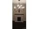 Elegant fireplace with hanging chandelier at 105 N Inman Ave, Bessemer City, NC 28016