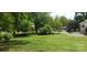 Expansive front yard with mature trees, manicured lawn, and view of the street at 105 N Inman Ave, Bessemer City, NC 28016