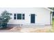 Exterior of a white home featuring a dark front door, a window, and meticulously laid stone steps at 105 N Inman Ave, Bessemer City, NC 28016