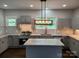 Modern kitchen with stainless steel appliances, granite countertops, and stylish gray cabinetry at 105 N Inman Ave, Bessemer City, NC 28016