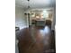 An open-concept kitchen featuring a large island, updated appliances, tile backsplash, and a decorative chandelier at 105 N Inman Ave, Bessemer City, NC 28016