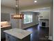 An open-concept kitchen with gray cabinets and a marble island at 105 N Inman Ave, Bessemer City, NC 28016