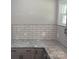Kitchen countertop features white subway tile backsplash and gray cabinets with black hardware at 105 N Inman Ave, Bessemer City, NC 28016