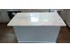 Kitchen island features a white countertop and stylish gray cabinetry at 105 N Inman Ave, Bessemer City, NC 28016