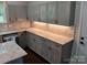 This kitchen features gray cabinets, white countertops, and stainless steel appliances at 105 N Inman Ave, Bessemer City, NC 28016