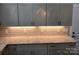 Kitchen boasts lots of storage with gray cabinets, white countertops, and subway tile backsplash at 105 N Inman Ave, Bessemer City, NC 28016