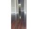 Hallway leading into a tile shower with beautiful dark hardwood floors at 105 N Inman Ave, Bessemer City, NC 28016