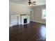Inviting living room with hardwood floors and a cozy fireplace, plus natural light at 105 N Inman Ave, Bessemer City, NC 28016