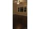 Living room with dark hardwood floors and a large window at 105 N Inman Ave, Bessemer City, NC 28016