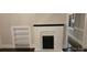Inviting living room showcasing a painted fireplace, shelving, and dark hardwood floors at 105 N Inman Ave, Bessemer City, NC 28016