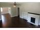 Cozy living room featuring hardwood floors and a fireplace with built in shelves at 105 N Inman Ave, Bessemer City, NC 28016
