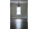 Neutral living room with dark wood floors and large window at 105 N Inman Ave, Bessemer City, NC 28016