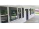 Covered porch with white railing, black shutters and door, and views of the yard at 105 N Inman Ave, Bessemer City, NC 28016