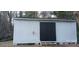 Exterior view of a large, light gray storage shed, ideal for storing outdoor equipment at 105 N Inman Ave, Bessemer City, NC 28016