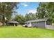 Spacious backyard with a large deck, well-maintained lawn, garage, and storage shed at 107 Deese Ct, Indian Trail, NC 28079