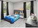 Bright bedroom with luxury vinyl floors and ample natural light from two windows at 107 Deese Ct, Indian Trail, NC 28079