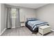 This is a neutral bedroom with a large bed, side table, and wooden floors at 107 Deese Ct, Indian Trail, NC 28079