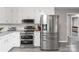 Modern kitchen with stainless steel appliances, white cabinets, and gray countertop at 107 Deese Ct, Indian Trail, NC 28079