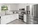 A bright and clean kitchen featuring stainless steel appliances and white cabinetry at 107 Deese Ct, Indian Trail, NC 28079