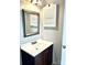 Bathroom with vanity, mirror, and cabinet; the fixtures offer a stylish and functional space at 10933 Harrowfield Rd, Charlotte, NC 28226