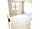 Spacious carpeted bedroom with neutral walls and a window at 10933 Harrowfield Rd, Charlotte, NC 28226