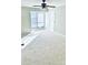 Spacious bedroom featuring neutral walls, plush carpeting, and a ceiling fan for added comfort at 10933 Harrowfield Rd, Charlotte, NC 28226